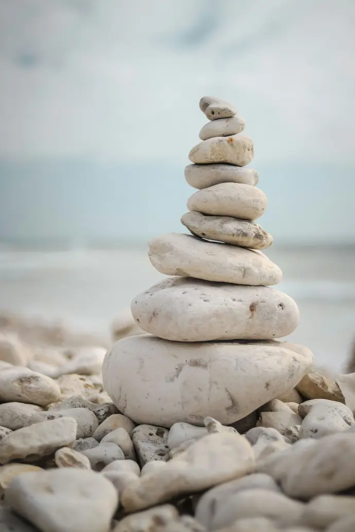 a stack of rocks sitting on top of a beach